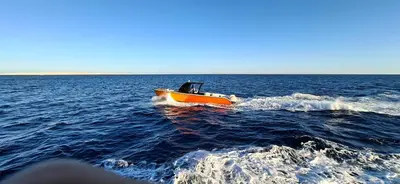 a small boat in the middle of the water at Tai Speedboat orange bay Island- Paradis Island- Dolphin - hula hula Island - Magawish island-etc in Hurghada