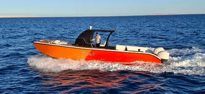 a man on a boat in the water at Tai Speedboat orange bay Island- Paradis Island- Dolphin - hula hula Island - Magawish island-etc in Hurghada