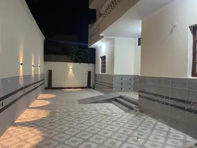 a hallway of a building with lights on the wall at Al-Fardous house in Luxor