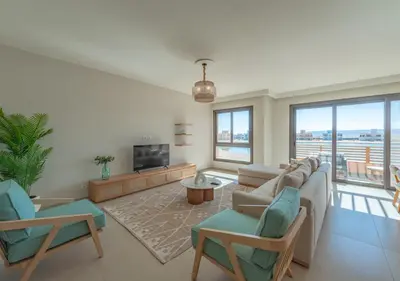 a living room with a couch and chairs and a tv at Ancient Hill 3BR Gouna Sea View & Priv Roof Pool in El Gouna