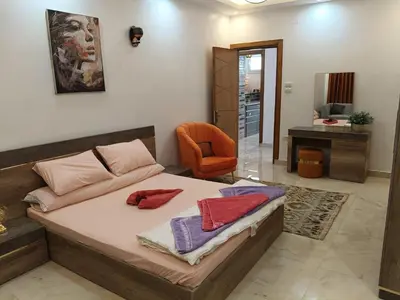 a bedroom with a bed and a chair at Aswan Nile View Dreams in Aswan