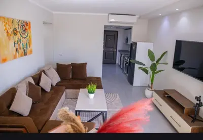 a living room with a couch and a tv at Scandic Resort Hurghada in Hurghada