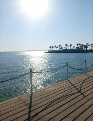 a wooden pier with a view of the ocean at Scandic Resort Hurghada in Hurghada