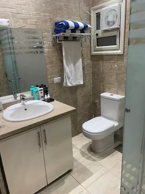 a bathroom with a toilet and a sink at Mirage bay resort in Hurghada