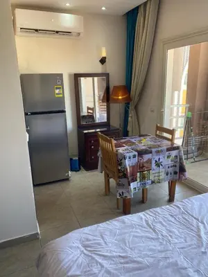 a kitchen with a table and a refrigerator at Mirage bay resort in Hurghada