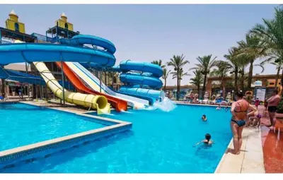 a water park with slides and people in the water at Mirage bay resort in Hurghada