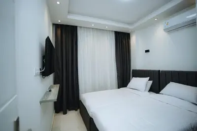a bedroom with two beds and a television in it at Selina Bay Resort in El Gouna