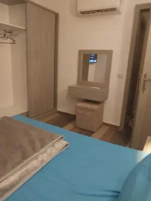 a room with a tv and a bed and a table at Royal residence in Marsa Alam