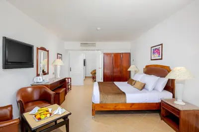 a hotel room with a bed and a chair at Marlin Inn Azur Resort in Hurghada