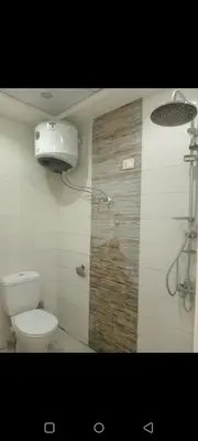 a bathroom with a toilet and a shower stall at Enter compound in Hurghada