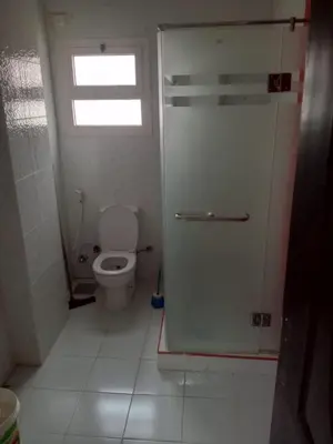 a small bathroom with a toilet and a window at Eslam apartment 2 in Hurghada