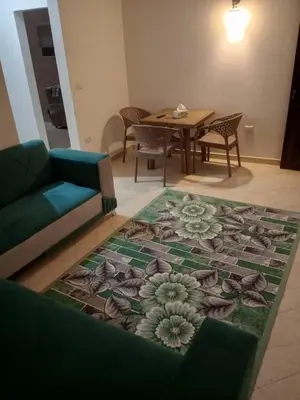 a living room with a couch and a table at Eslam Apartments in Hurghada