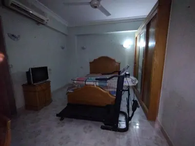 a bedroom with a bed and a tv in a room at جبل تقوق فيلا عبدالله محروس in Nag` el-Ramla