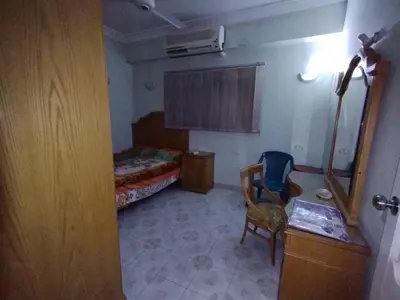 a room with a bedroom with a bed and a chair at جبل تقوق فيلا عبدالله محروس in Nag` el-Ramla