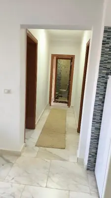 a hallway with a door and a rug on the floor at Paradise Hill in Hurghada