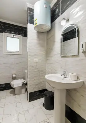 a bathroom with a sink and a toilet at Luxury City Center One-Bedroom Suite by Peaks in Hurghada