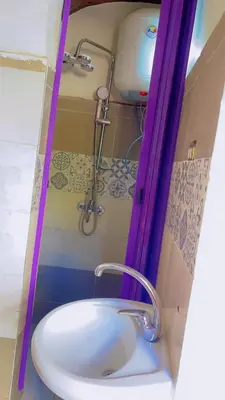 a bathroom with a white sink and a shower at the little house in Aswan