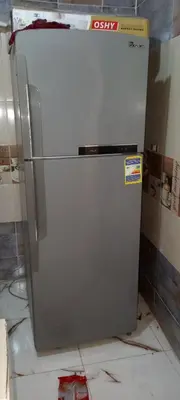 a white refrigerator sitting on top of a floor at the little house in Aswan