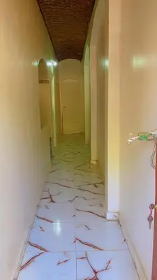a hallway with a door and a tile floor at the little house in Aswan