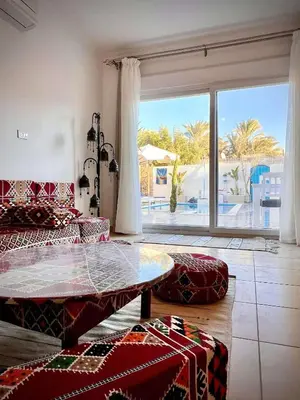 a living room with a table and a large window at Touristic Center in Hurghada