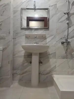 a bathroom with a sink and a mirror on the wall at Tiba Golden Resort apartment 167 in Hurghada
