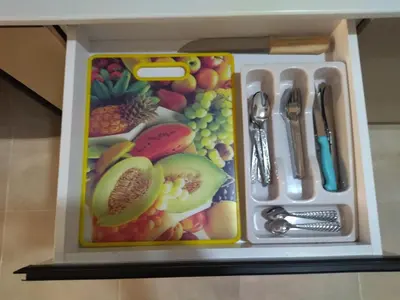 a lunch box with fruits and vegetables and utensils at Tiba Golden Resort apartment 167 in Hurghada