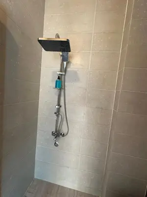 a shower in a bathroom with a shower head at Palm Guest House in Aswan