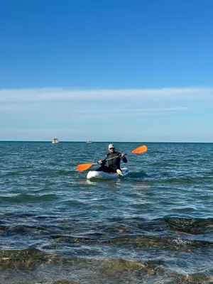 a man is in a kayak in the ocean at Fanadir bay in Hurghada