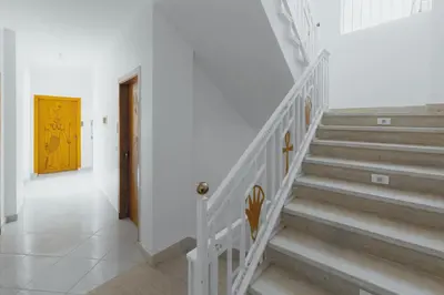 a staircase in a house with a yellow door at Pharaohs Guest House in Luxor