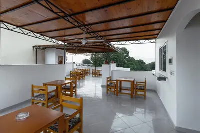 a dining room with wooden tables and chairs at Pharaohs Guest House in Luxor
