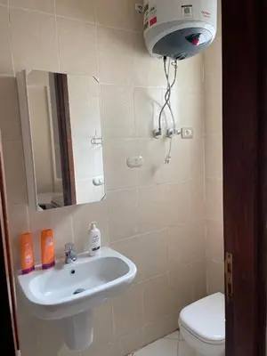 a bathroom with a sink and a toilet at Serene Apartment Makadi Heights in Hurghada