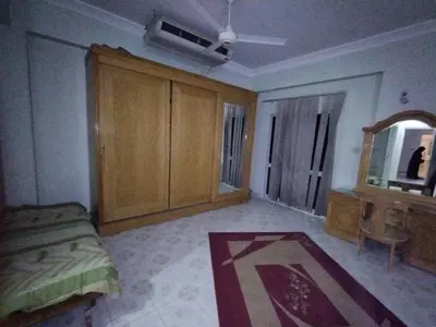 a bedroom with a bed and a dresser and a mirror at فيلا عبدالله محروس in Aswan