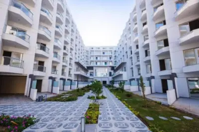 a large apartment building with a pathway in front of it at Scandic Resort Hurghada in Hurghada