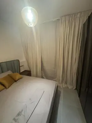 a bedroom with a white bed and a light at luxury apartment Makadi heights phase 2 in Hurghada