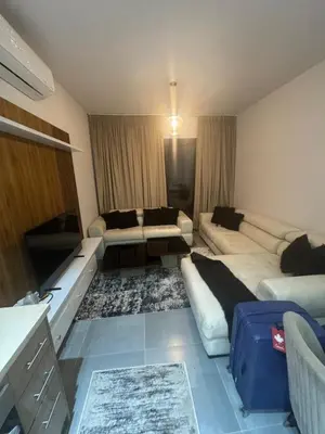 a living room with a couch and a tv in it at luxury apartment Makadi heights phase 2 in Hurghada