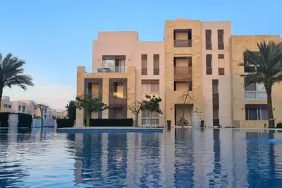 a building with a pool of water in front of it at Mangroovy 1 br Ground Composure & Cool Hilton view in Hurghada