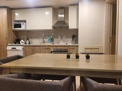 a kitchen with a large wooden table with chairs at Mangroovy 1 br Ground Composure & Cool Hilton view in Hurghada