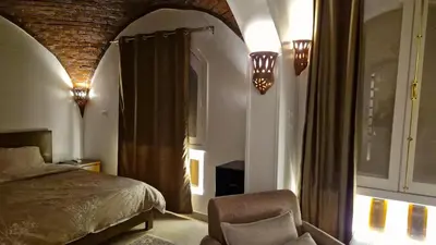 a bedroom with a bed and a chair in a room at House Mountain in ‘Ezbet Abu Ḥabashi