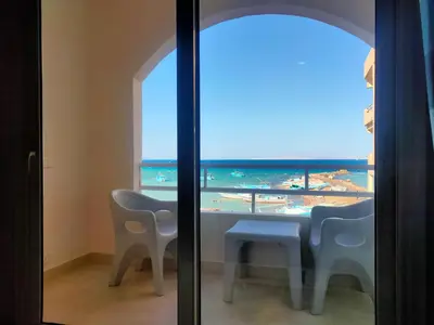 a room with a table and chairs and a view of the ocean at Aquarium Seaview accomodations in Hurghada