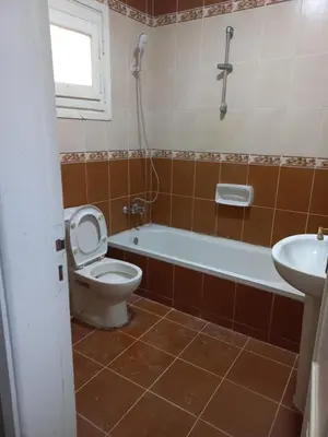 a bathroom with a toilet and a tub and a sink at شقة فندقية على البحر منطقة القيادات 2 in Hurghada