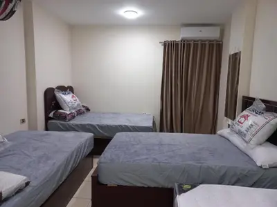 a room with two beds and a window at شقة فندقية على البحر منطقة القيادات 2 in Hurghada