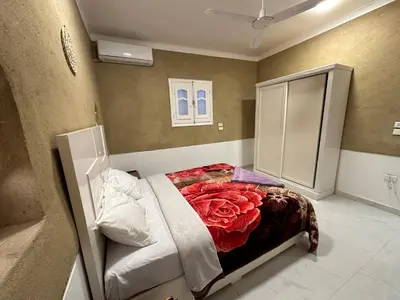 a bedroom with a bed with a red rose at Tuya House Luxor in Luxor