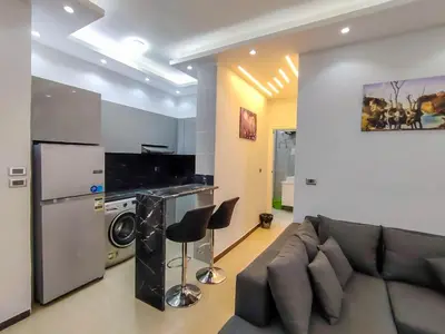 a living room with a couch and a kitchen at Sea view one bedroom apartment in Hurghada Dreams in Hurghada