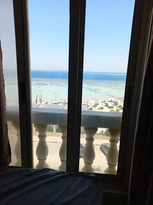 a view of the beach from a room with a window at شقة فندقية على البحر مباشرا 2 in Hurghada
