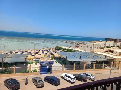 a group of cars parked in a parking lot near the beach at شقة فندقية على البحر مباشرا 2 in Hurghada