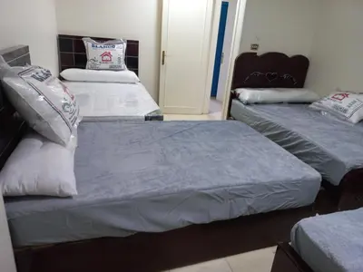 two beds in a room with two beds sidx sidx sidx at شقة فندقية على البحر مباشرا 2 in Hurghada
