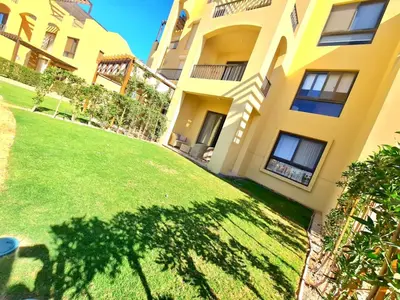 an apartment building with a lawn in front of it at Elgouna, Tawila island in Hurghada