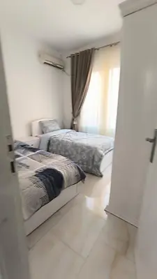 a bedroom with two beds and a window at Paradise Hill 207 in Hurghada