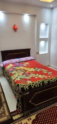 a bedroom with a bed with a colorful blanket at Little Private Palace in Luxor in Luxor
