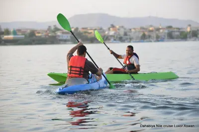 two men are kayaking on a body of water at Little Private Palace in Luxor in Luxor